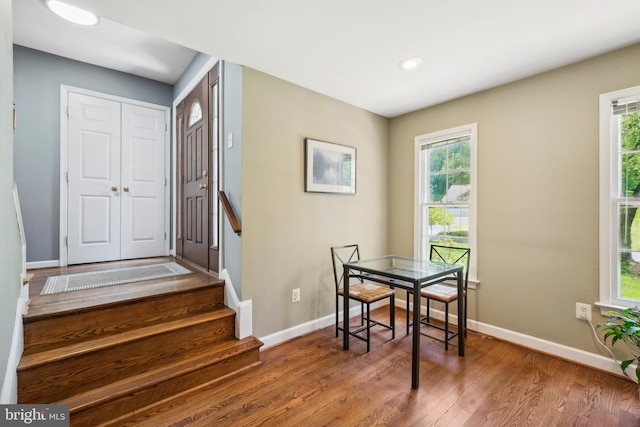 entryway featuring wood finished floors, baseboards, healthy amount of natural light, stairway, and recessed lighting