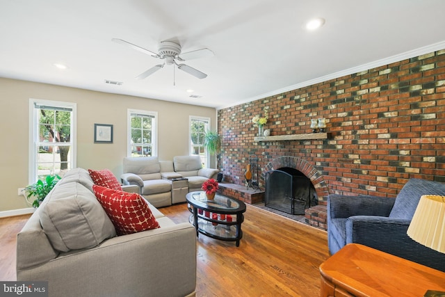 living room with plenty of natural light, ceiling fan, a brick fireplace, wood finished floors, and recessed lighting