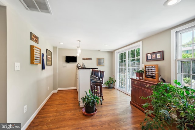dining room with wood finished floors, baseboards, and recessed lighting