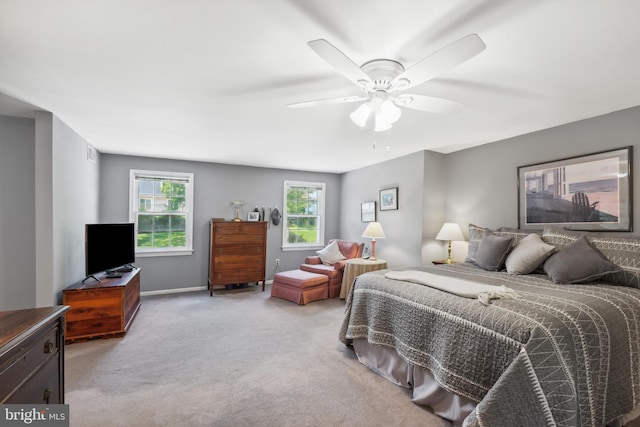 carpeted bedroom with a ceiling fan and baseboards