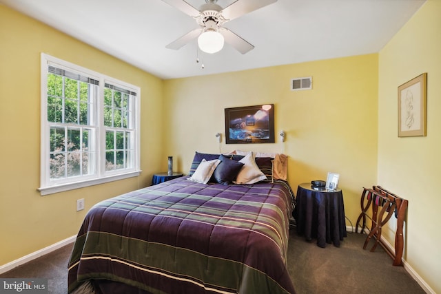 carpeted bedroom featuring baseboards and a ceiling fan
