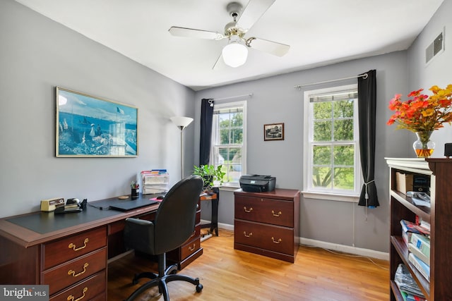 office area featuring light wood-type flooring, baseboards, and a ceiling fan