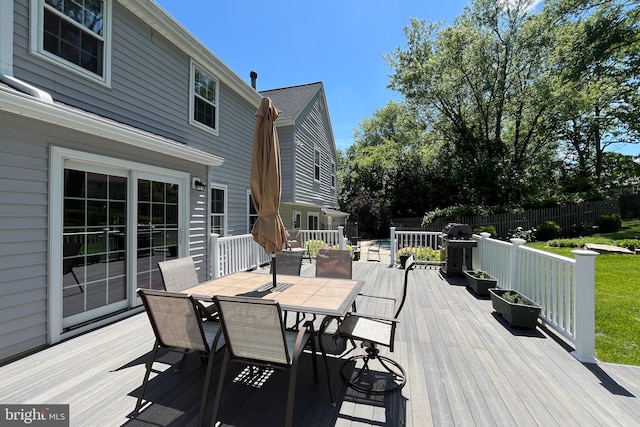 wooden deck featuring outdoor dining area and area for grilling