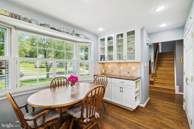 dining space featuring dark wood-style floors, recessed lighting, stairs, and baseboards