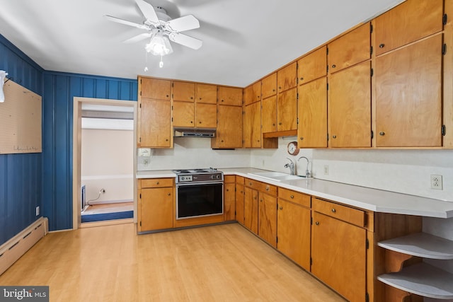 kitchen featuring a sink, electric range, under cabinet range hood, a baseboard heating unit, and light wood-type flooring