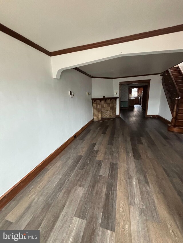 3313 Saint Vincent St, Philadelphia, PA 19149 - unfurnished living room with baseboards, stairway, dark wood finished floors, and crown molding