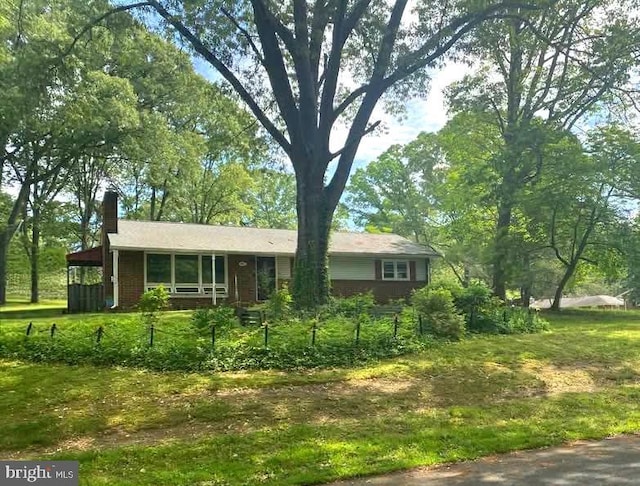 407 Stately Dr, Pasadena, MD 21122 - view of front of house with a chimney and brick siding