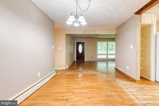 407 Stately Dr, Pasadena, MD 21122 - entrance foyer with a baseboard heating unit, light wood finished floors, a chandelier, baseboards, and a textured ceiling