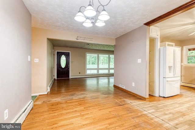 407 Stately Dr, Pasadena, MD 21122 - entryway featuring a chandelier, light wood finished floors, plenty of natural light, and a baseboard heating unit