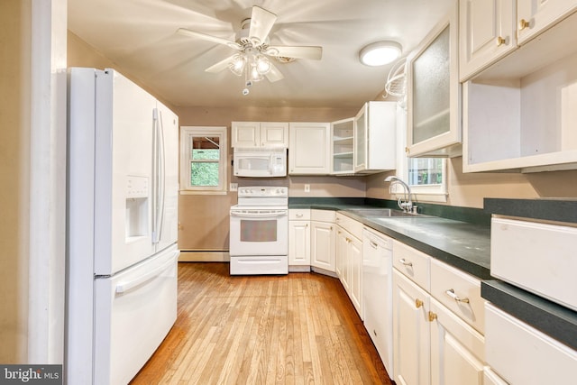 407 Stately Dr, Pasadena, MD 21122 - kitchen featuring white appliances, a sink, a baseboard heating unit, light wood finished floors, and dark countertops