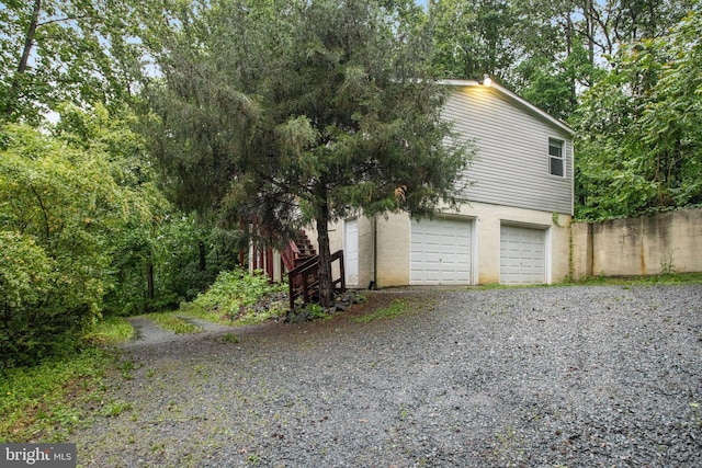 61 Brent Point Rd, Stafford, VA 22554 - view of side of home with an attached garage, fence, and gravel driveway