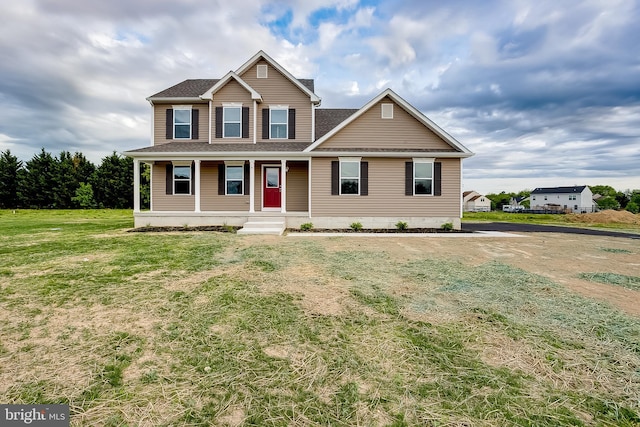 view of front of home with covered porch and a front yard