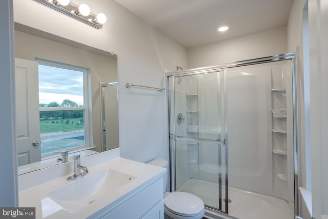 full bathroom featuring vanity, toilet, a shower stall, and recessed lighting