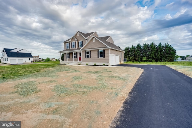 craftsman-style house featuring covered porch, a garage, and driveway