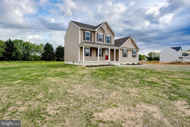 view of front of house featuring a front lawn and covered porch