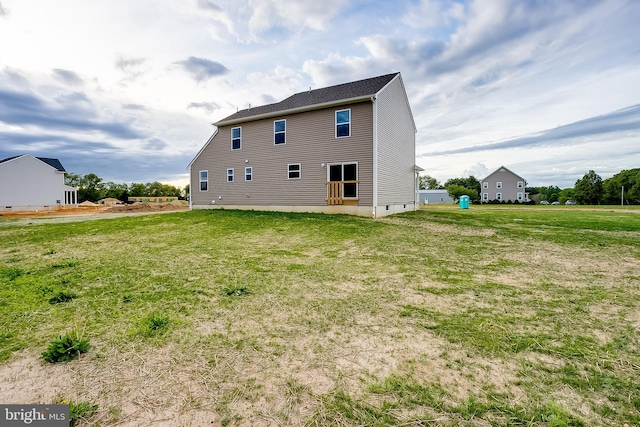 rear view of house with a lawn