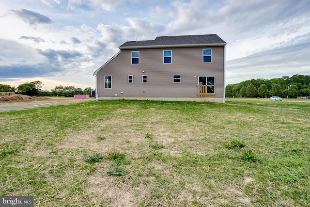 back of property with a yard