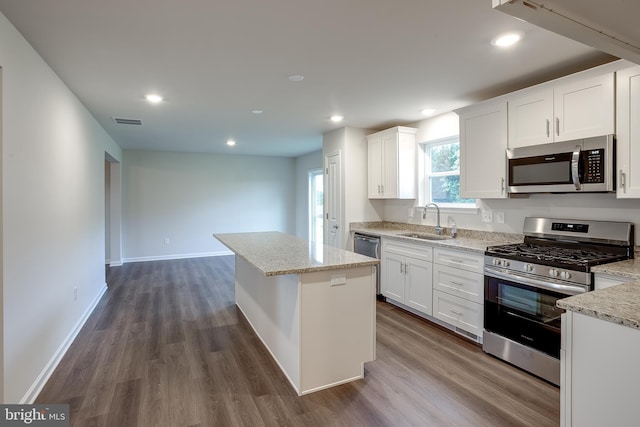 kitchen with dark wood-style floors, visible vents, appliances with stainless steel finishes, and a sink