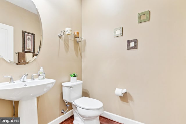 40999 Waxwing Dr, Leesburg, VA 20175 - half bath with wood finished floors, toilet, and baseboards