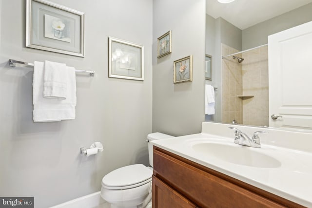 40999 Waxwing Dr, Leesburg, VA 20175 - full bathroom with toilet, vanity, a shower, and baseboards