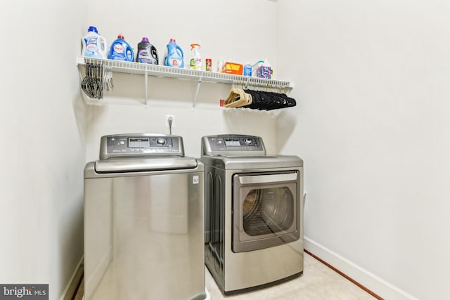 40999 Waxwing Dr, Leesburg, VA 20175 - washroom featuring independent washer and dryer, tile patterned flooring, and baseboards
