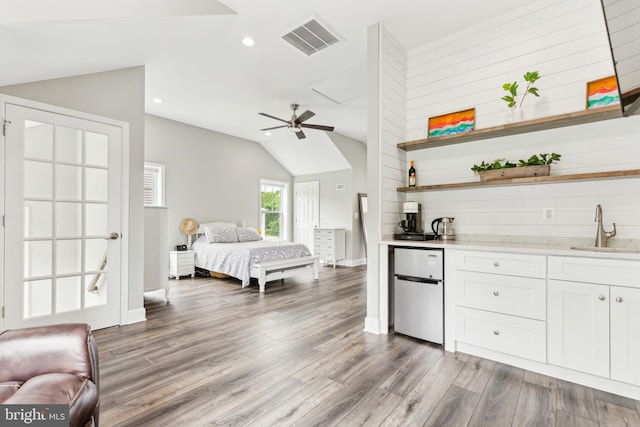 40999 Waxwing Dr, Leesburg, VA 20175 - bedroom featuring a sink, freestanding refrigerator, lofted ceiling, wood finished floors, and recessed lighting