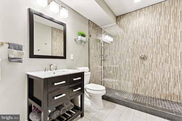 40999 Waxwing Dr, Leesburg, VA 20175 - bathroom with toilet, a tile shower, and vanity