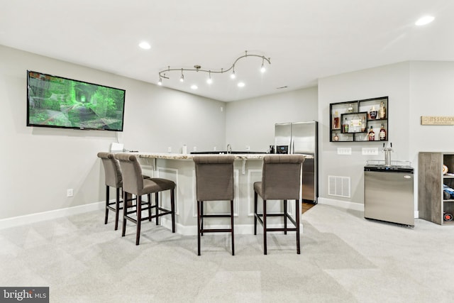 40999 Waxwing Dr, Leesburg, VA 20175 - kitchen with stainless steel refrigerator with ice dispenser, fridge, a breakfast bar area, light carpet, and recessed lighting