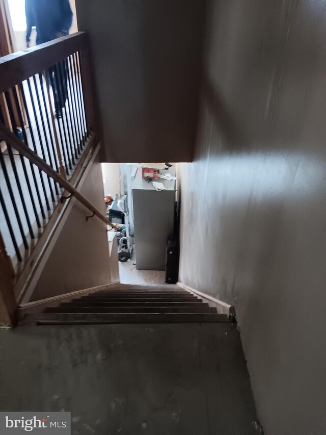 staircase featuring concrete floors