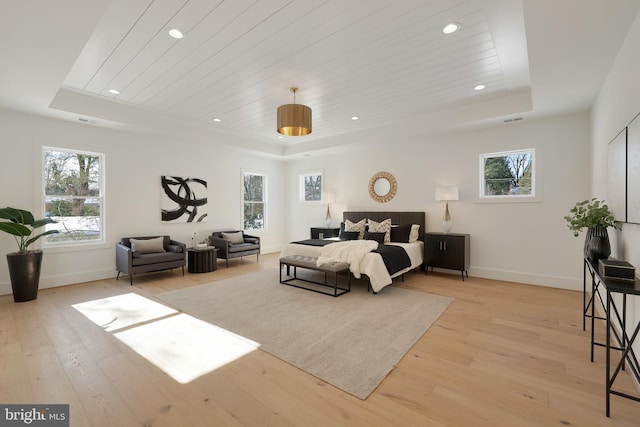 bedroom with a tray ceiling, multiple windows, recessed lighting, and wooden ceiling