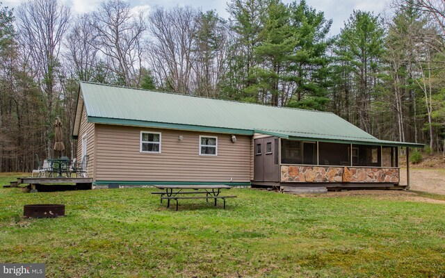 220 Gillens Rd, Mill Hall, PA 17751 - back of property featuring a sunroom, metal roof, a yard, and a deck