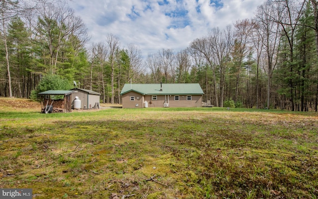 220 Gillens Rd, Mill Hall, PA 17751 - view of grassy yard featuring an outbuilding, a view of trees, and a shed
