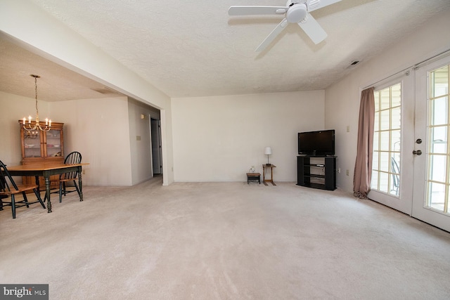 4801 Vesper Cir, Palmyra, NJ 08065 - unfurnished living room with french doors, a chandelier, carpet flooring, a ceiling fan, and a textured ceiling
