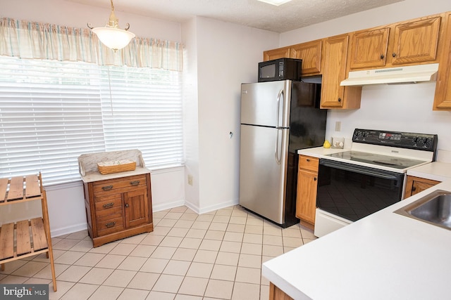 4801 Vesper Cir, Palmyra, NJ 08065 - kitchen with under cabinet range hood, electric range, freestanding refrigerator, light countertops, and baseboards