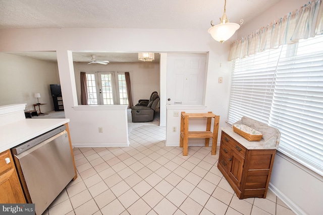 4801 Vesper Cir, Palmyra, NJ 08065 - kitchen with stainless steel dishwasher, light countertops, light tile patterned floors, a ceiling fan, and baseboards