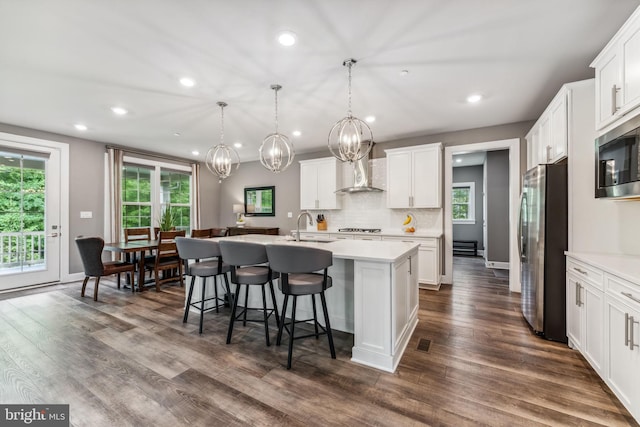 803 Rexford Way, Upper Marlboro, MD 20774 - kitchen featuring appliances with stainless steel finishes, wall chimney range hood, a sink, recessed lighting, and a kitchen island with sink