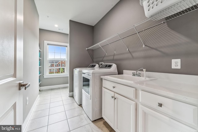 803 Rexford Way, Upper Marlboro, MD 20774 - clothes washing area with washing machine and clothes dryer, light tile patterned floors, baseboards, and cabinet space