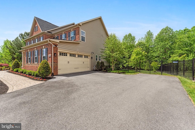 803 Rexford Way, Upper Marlboro, MD 20774 - view of side of home with brick siding, asphalt driveway, fence, and an attached garage
