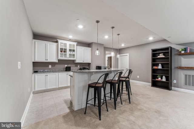 803 Rexford Way, Upper Marlboro, MD 20774 - kitchen with light colored carpet, baseboards, white cabinets, a kitchen bar, and recessed lighting