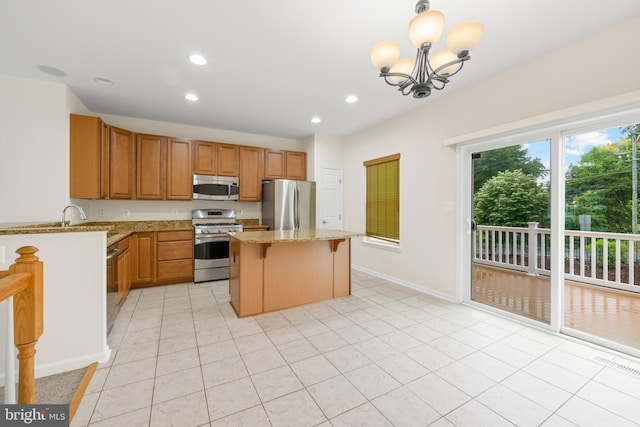 107 Bancroft Dr Unit 96, Fredericksburg, VA 22405 - kitchen featuring appliances with stainless steel finishes, a kitchen island, light stone countertops, recessed lighting, and a kitchen breakfast bar
