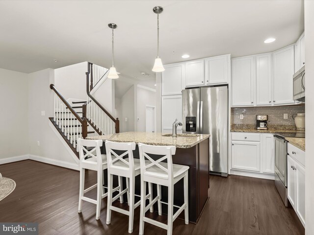300 Grace Way, Laurel, MD 20707 - kitchen with appliances with stainless steel finishes, dark wood-type flooring, a kitchen island with sink, light stone countertops, and recessed lighting