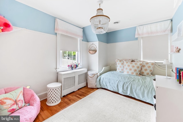 533 Park Ave, Towson, MD 21204 - bedroom with wood finished floors and a chandelier