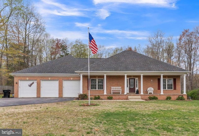 8200 Marshall Corner Rd, Pomfret, MD 20675 - view of front of home featuring an attached garage, driveway, a front yard, a porch, and brick siding