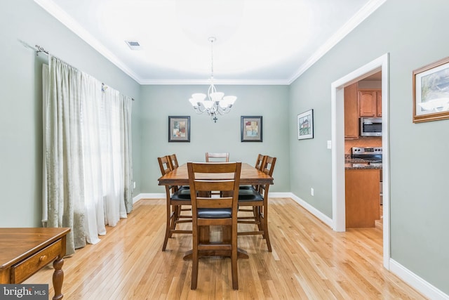8200 Marshall Corner Rd, Pomfret, MD 20675 - dining space featuring light wood finished floors, a chandelier, crown molding, and baseboards