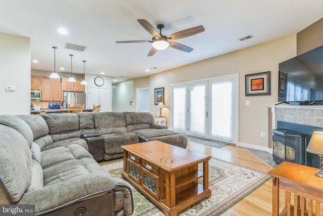 8200 Marshall Corner Rd, Pomfret, MD 20675 - living area with light wood-style flooring, ceiling fan, a wood stove, recessed lighting, and baseboards