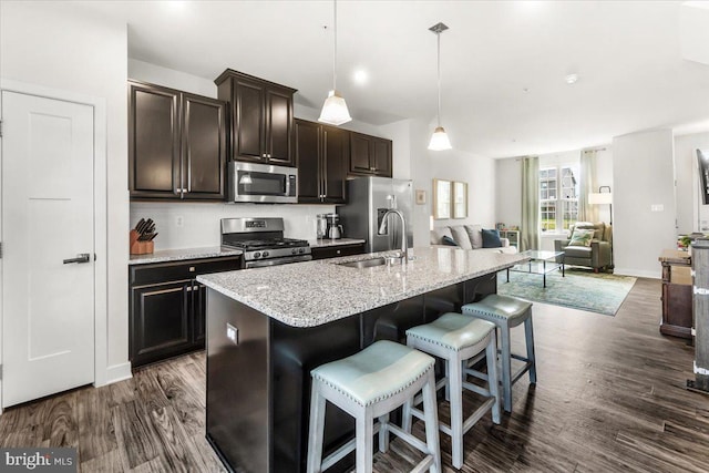10732 Lamoka Ln, New Market, MD 21774 - kitchen with appliances with stainless steel finishes, a sink, dark wood-type flooring, a breakfast bar, and open floor plan