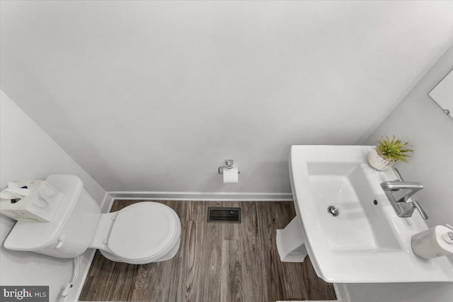 10732 Lamoka Ln, New Market, MD 21774 - bathroom featuring wood finished floors, toilet, and a sink