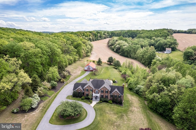 view from above of property featuring a heavily wooded area