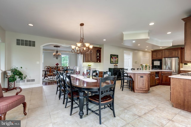 dining area featuring a chandelier, light tile patterned floors, recessed lighting, arched walkways, and ornamental molding