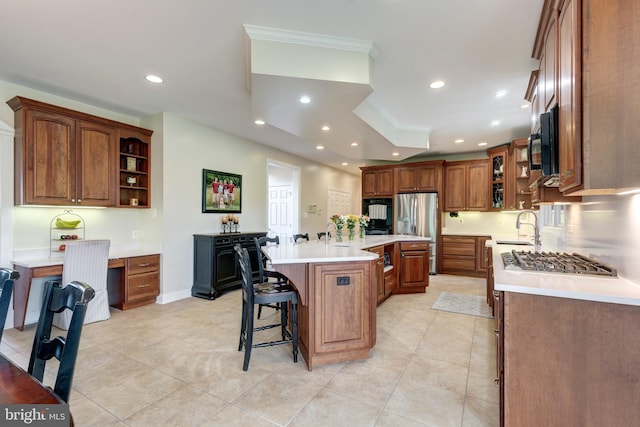 kitchen with appliances with stainless steel finishes, a sink, ornamental molding, light countertops, and recessed lighting
